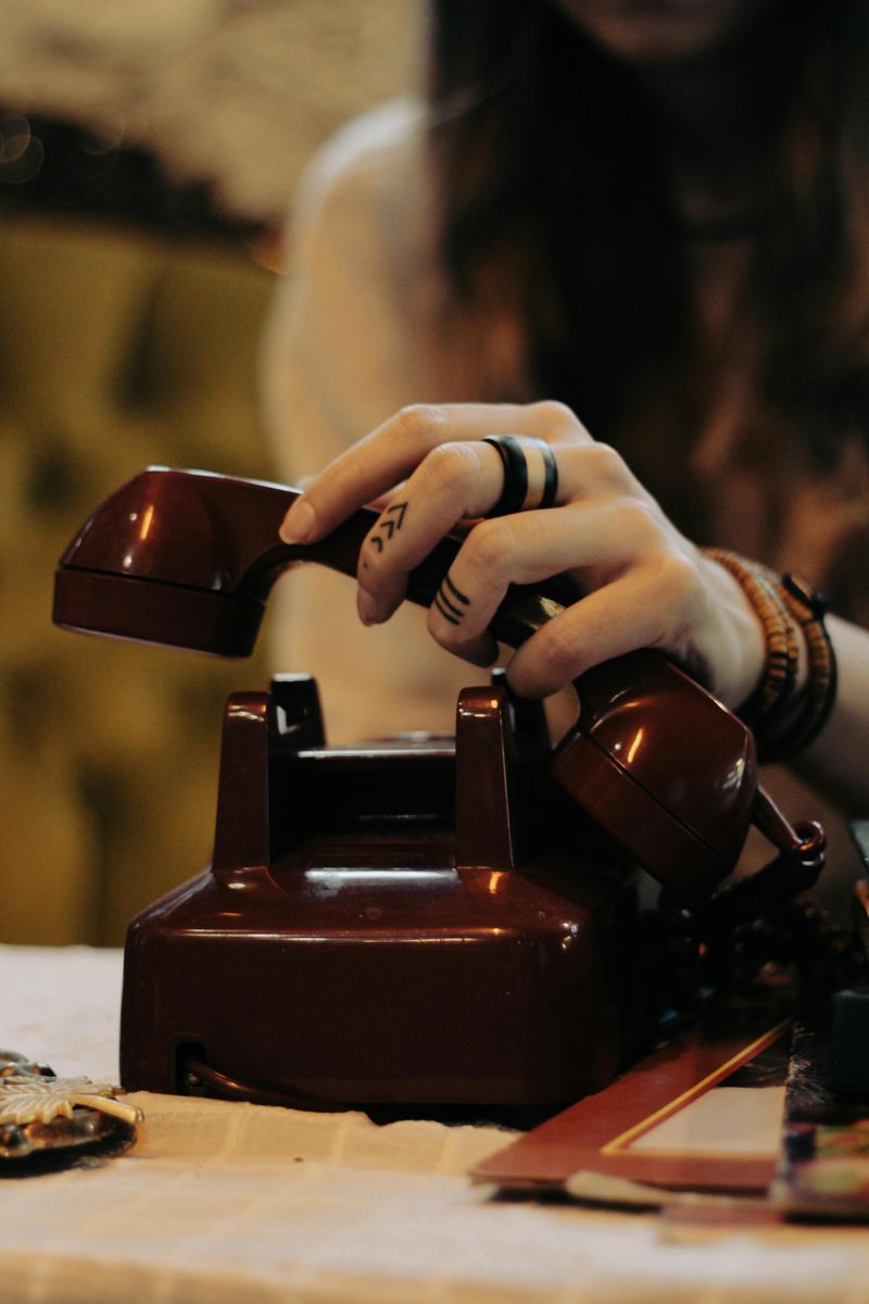 A guest picking up the vintage phone to leave a spoken memory