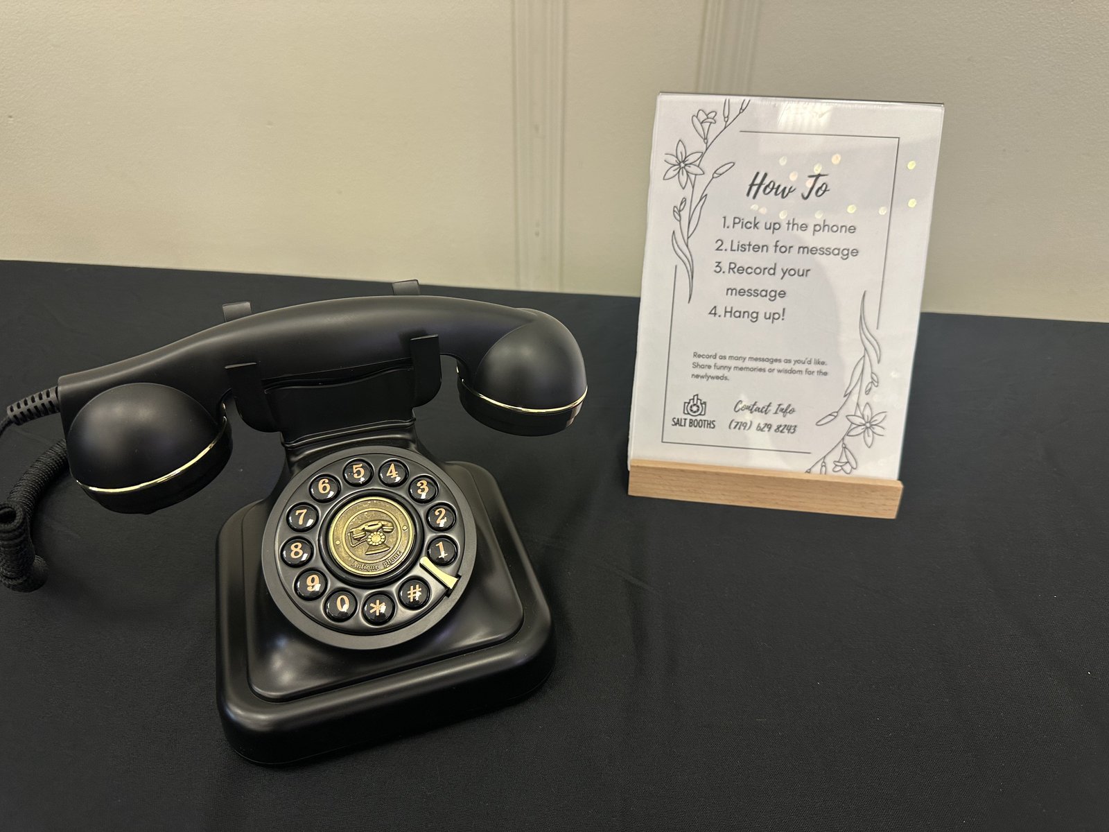 Salt Booths audio guestbook: vintage black rotary phone with custom How To card showing pick up, listen, record, hang up