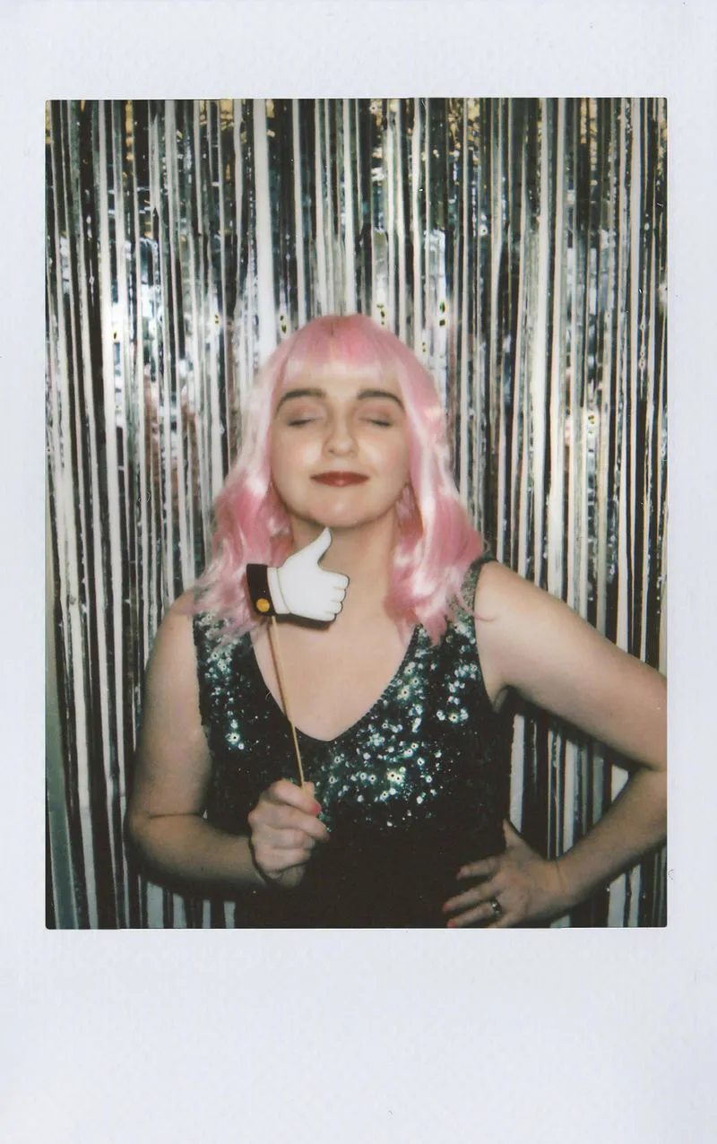 Guest in a pink wig, photo booth polaroid