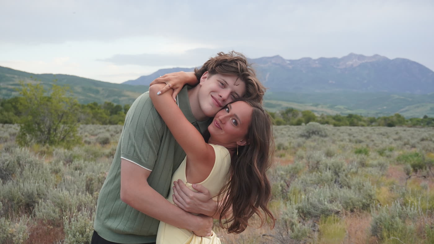 Young couple hugging at an outdoor mountain wedding