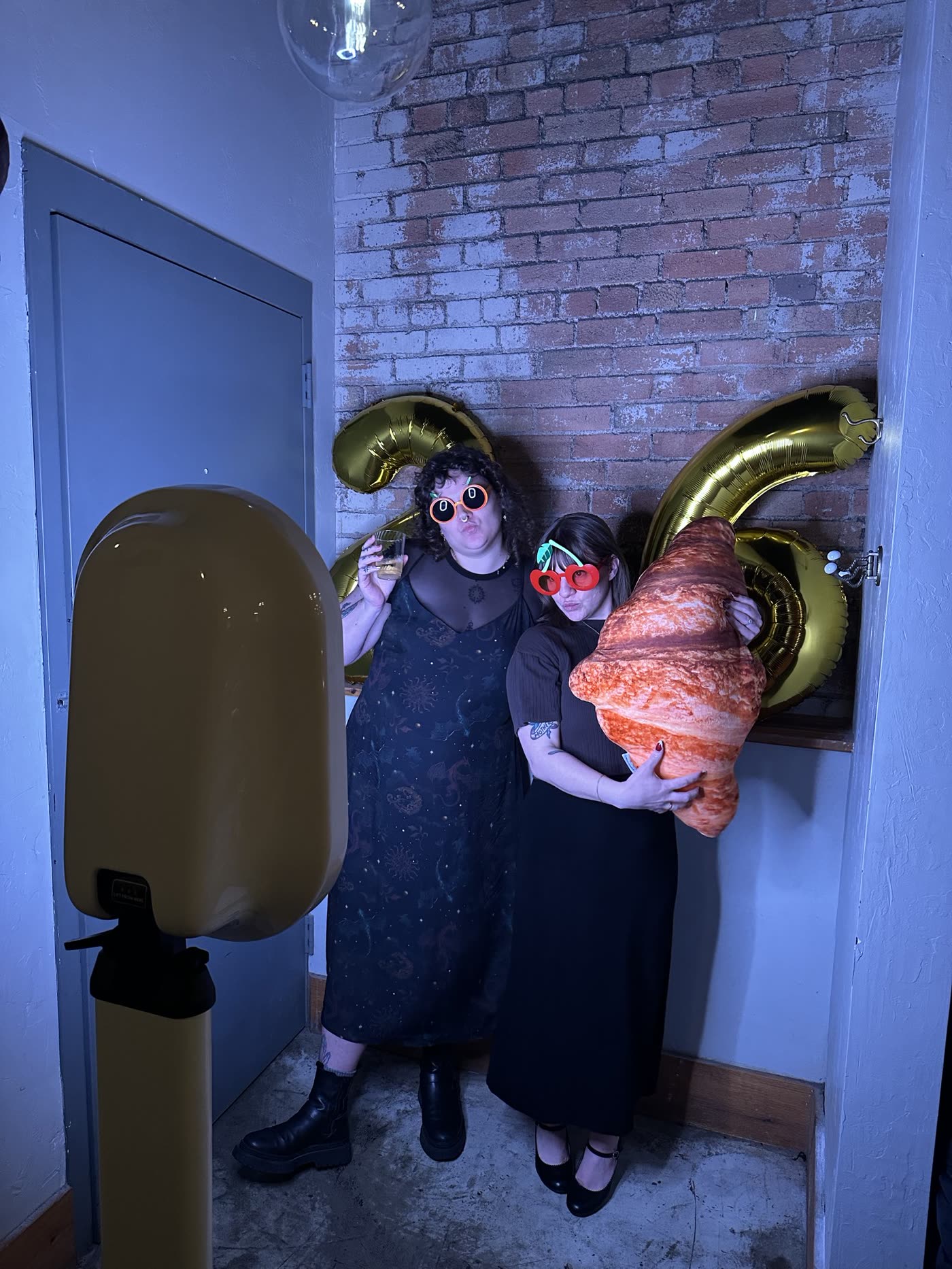 Guests posing with a giant croissant balloon