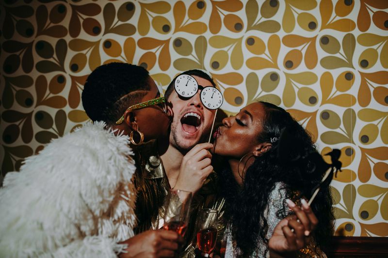 Guests posing with props at the photo booth
