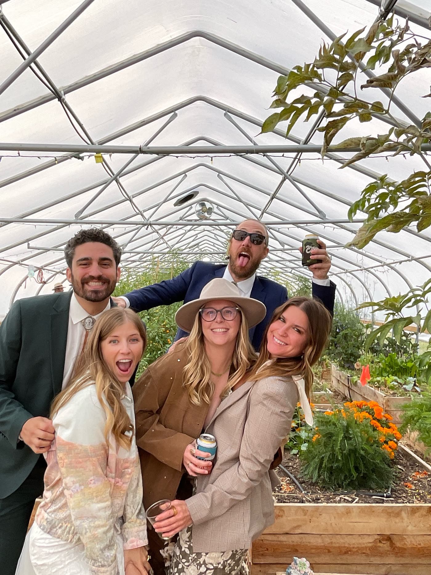 Wedding group portrait in greenhouse